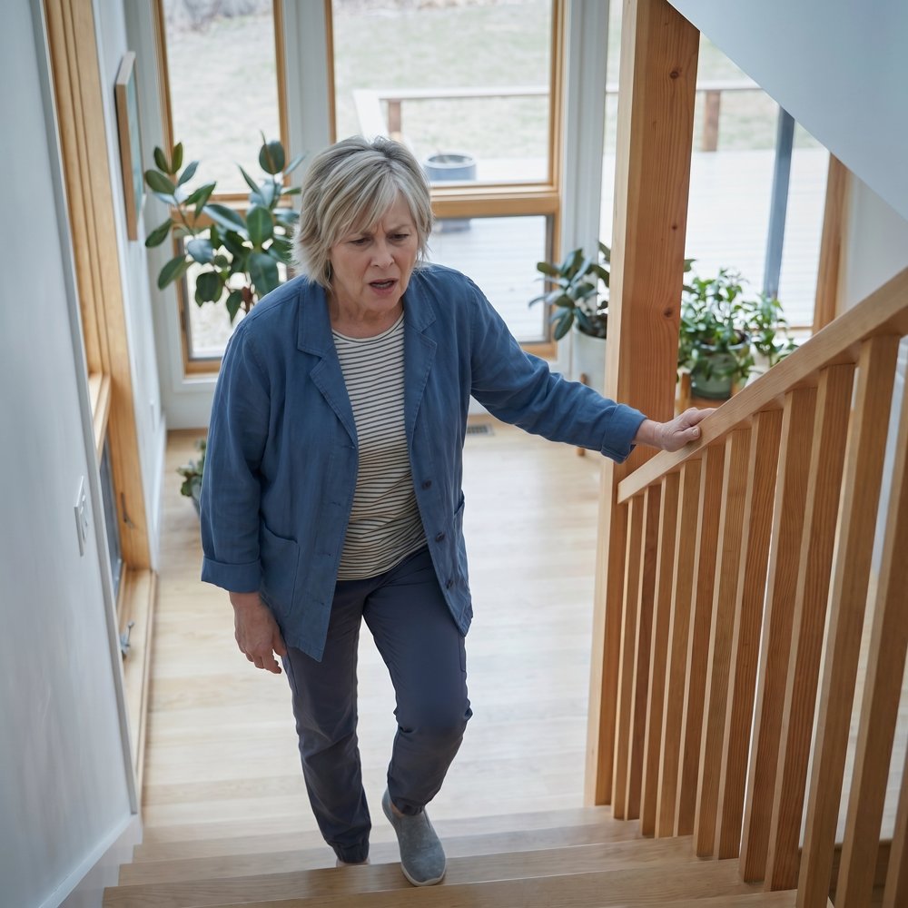 Older woman struggling on the stairs