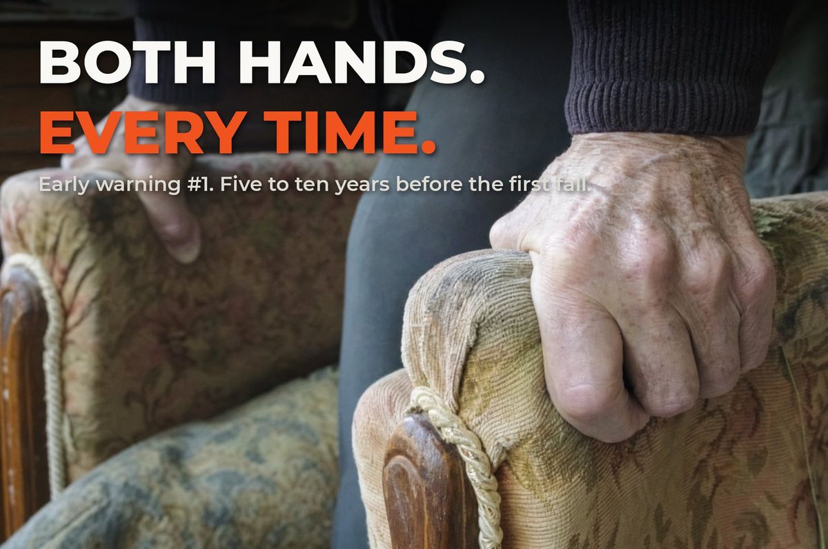 Weathered hands gripping chair armrests to stand up