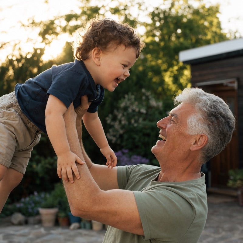A grandparent lifting a grandchild