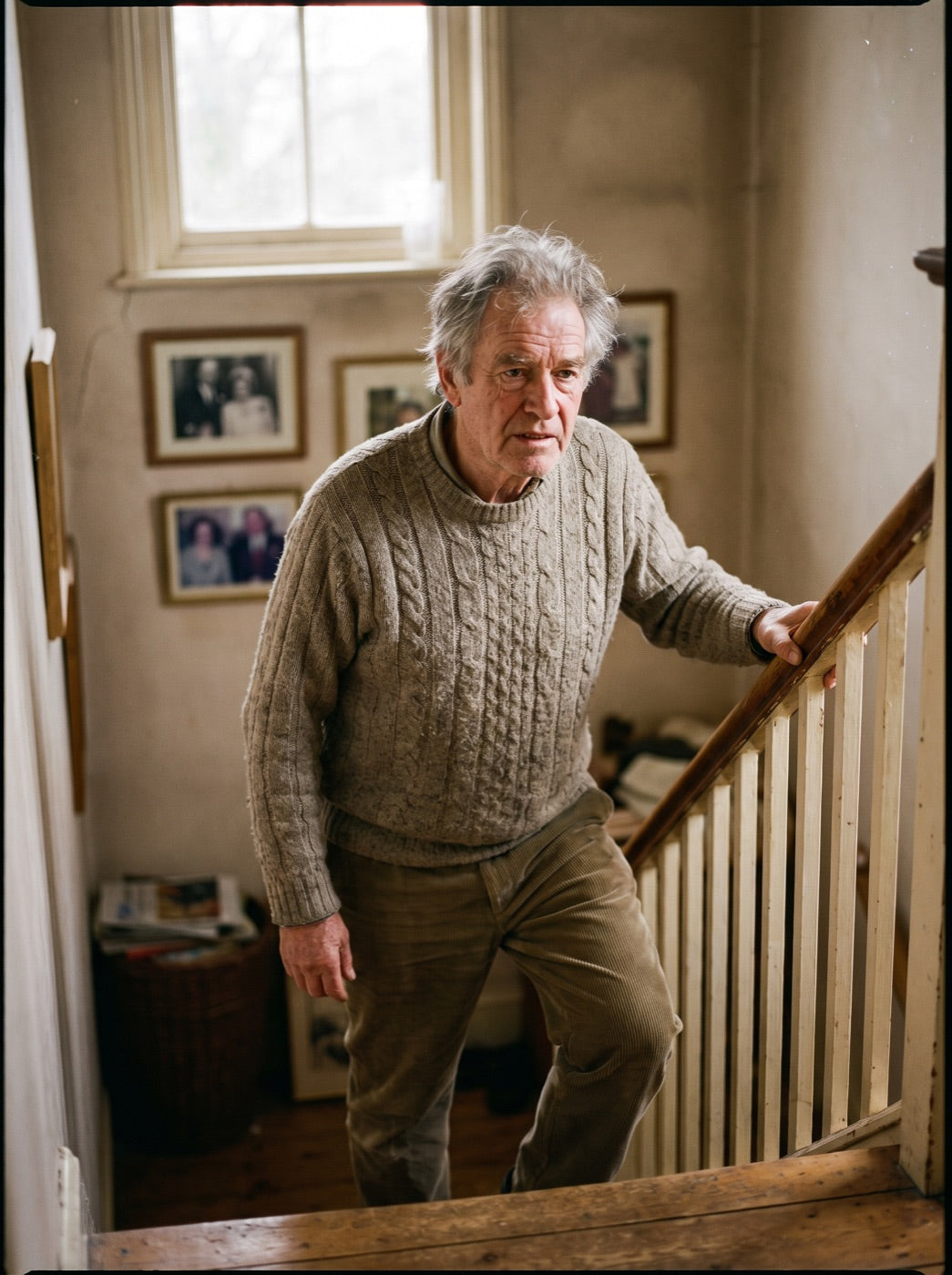 A man climbing stairs holding the handrail
